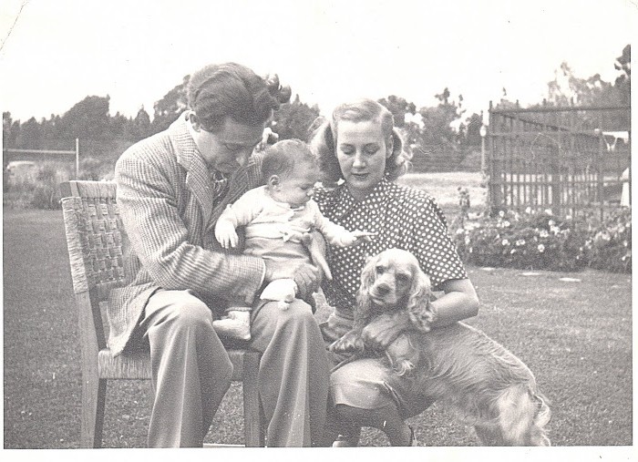 The Young Robin Family at Home. Leo is tenderly holding his new son, Marshall, with his wife, Fran, by their side.  Their pet cocker spaniel strikes a pose, too!