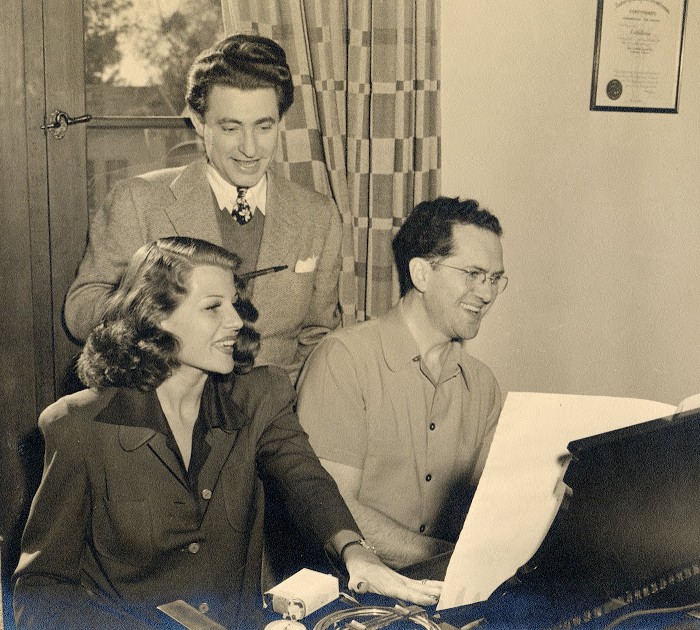 Leo Robin and Ralph Rainger with glamorous film star Rita Hayworth working on My Gal Sal in their bungalow on the Paramount lot in 1942.