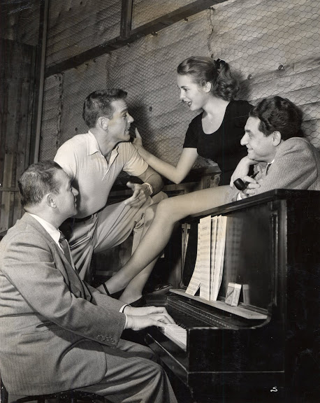 Rehearsing in the studio in 1955 for My Sister Eileen. Clockwise: Jule Styne at the piano; choreographer Gower Champion who was working on a different film for Columbia nearby and apparently dropped by that day to say hi; film actress Janet Leigh and lyricist Leo Robin; Gower and Janet already knew each other since he had helped her with her dancing four years earlier on Two Tickets to Broadway.