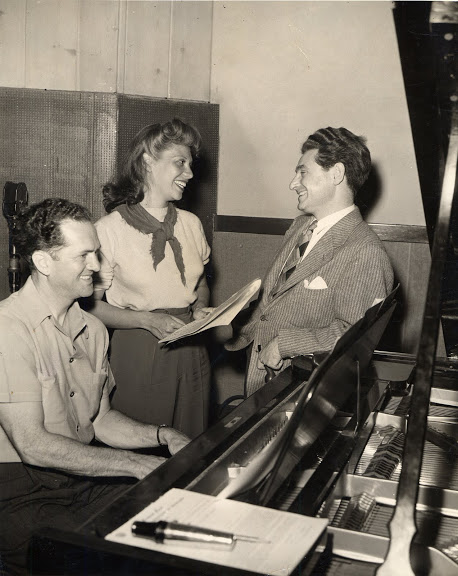 Leo Robin and Ralph Rainger with singer-actress Dinah Shore rehearsing at a recording studio.