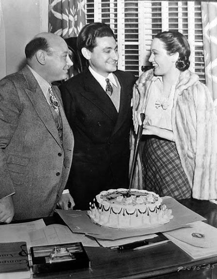 A slice of birthday cake. Actress-Singer Dorothy Lamour and Paramount's music director Boris Morros at Leo Robin's surprise birthday party on April 6, 1938